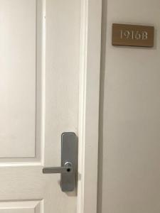 ajar door with ajar handle on a white door at The Bahamas & Maldives Suites at Azure Residences near Manila Airport in Manila