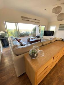 a living room with a couch and a table at Russell's Secluded Secret in Russell