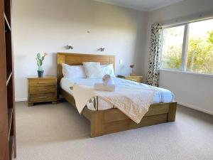a child sitting on a bed in a bedroom at Russell's Secluded Secret in Russell