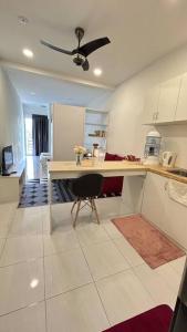 a kitchen with a table and a ceiling fan at SohoMimi Seri Iskandar in Kampung Bota Kiri +5 photos