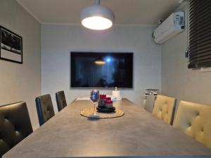 ein Esszimmer mit einem Tisch und einem Glas Wein in der Unterkunft 잠실역 근처 가족숙소 더하리하우스 in Seoul