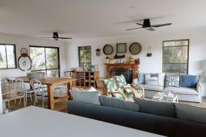 a living room with a couch and a table at Family Fun On The Farm! Close to Kenilworth Stylish Feed Friendly Cows Breathtaking 360 Views in Obi Obi