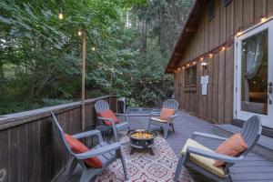 a patio with chairs and a fire pit on a deck at Bear Paw by NW Comfy Cabins in Leavenworth
