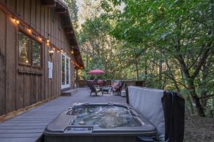 a hot tub on the porch of a house at Bear Paw by NW Comfy Cabins in Leavenworth