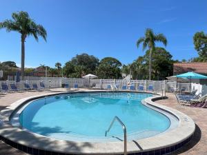 a large swimming pool with chairs and palm trees at Florida Bella Rosa near IMG Academy & beaches in Bradenton