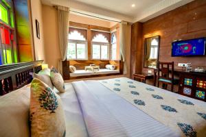 a bedroom with a large bed in a room at Kankariya Heritage in Jodhpur