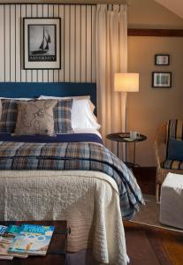 a bedroom with a bed and a chair at Abbey's Lantern Hill Inn in Ledyard Center