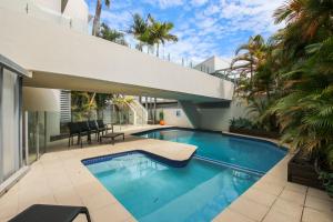 a swimming pool in the backyard of a house at Monterey Lodge Unit 17, 27 Warne Tce Kings Beach in Caloundra