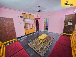 a room with pink walls and a table and a door at wanderwells in Visakhapatnam