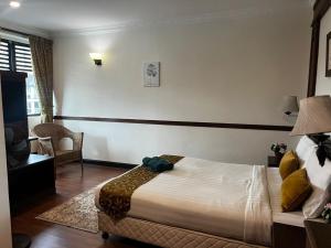 Postel nebo postele na pokoji v ubytování Melur Inn