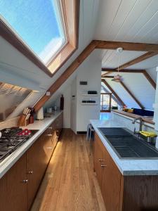 a kitchen with wooden cabinets and a skylight at Iconic Gesner Boat House Wview Of Hollywood Sign in Los Angeles