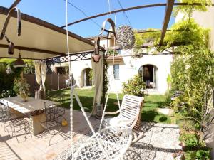 Un patio con un columpio y sillas en un patio. en Tuscan Retreat in Aiale, en Lari