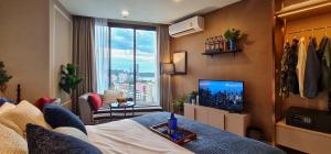 a living room with a view of a city at EDGE Central Pattaya Super Condo in Pattaya Central