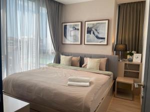 a bedroom with a large bed and a window at EDGE Central Pattaya Super Condo in Pattaya Central