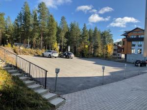 a parking lot with two cars parked in it at Lumi City Apartment in Levi