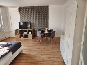 a bedroom with a dining room table and chairs at LIZO Deluxe apartman in Székesfehérvár