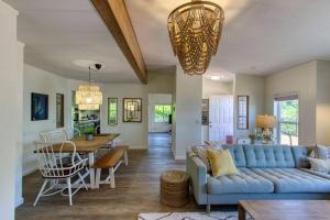 a living room with a blue couch and a table at Serene & Luxury Retreat, Waterfront, Hot tub, Clamming in Lilliwaup +16 photos