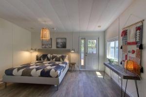 a bedroom with a bed and a table in it at Serene & Luxury Retreat, Waterfront, Hot tub, Clamming in Lilliwaup