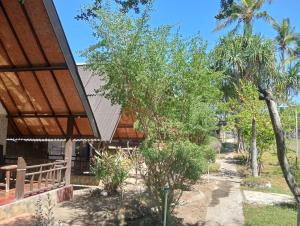a view of a house with a tree at Tropicana Gili in Gili Meno