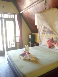Ένα ή περισσότερα κρεβάτια σε δωμάτιο στο Tropicana Gili