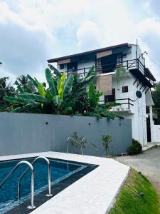 a house with a swimming pool in front of a building at Hotel Vish Ceylon in Talawatugoda