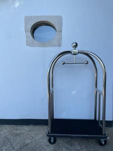 a luggage cart sitting in front of a blue wall at Le Petit Bois in Sainte-Marie-de-Ré