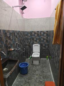 a small bathroom with a sink and a toilet at Ram Ganga Valley Homestay in Sater +7 photos