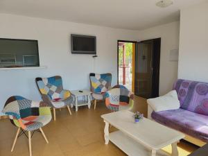 a living room with a couch and chairs and a table at La Jaima in Prado del Rey