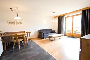 a living room with a table and a couch at Haus Prieth in Nauders