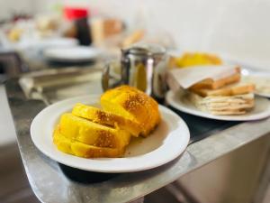 zwei Teller mit Essen auf einer Theke mit Brot in der Unterkunft Blue Moon Residency in Islamabad