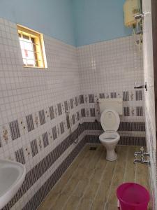 a bathroom with a toilet and a sink at Travelmate Vagamon in Vagamon