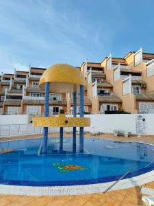 a fountain in a swimming pool in front of a building at Costa Adeje Orlando Tenerife Sea View - Pool - AC in Adeje