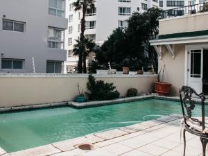 a swimming pool in front of a building at Craigrownie Luxury Guest House in Cape Town