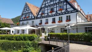a black and white building with a bridge in front of it at Bad Hotel Bad Überkingen in Bad Überkingen