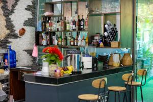 a bar with a counter with stools and bottles at MiChoc Homestay - Hostel in Ninh Binh
