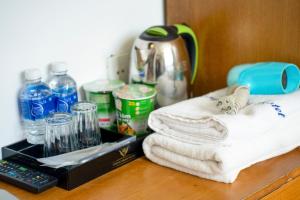 a counter with towels and bottles of water and a thermos at Trang Ngan Hotel by THG in Danang