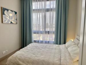 Postel nebo postele na pokoji v ubytování Lotus Apartment Hawana Salalah + 9 fotografií