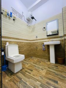 a bathroom with a toilet and a sink at Peacock Villa in Welihinda +16 photos