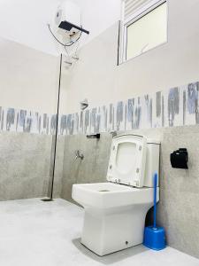 a bathroom with a toilet with a camera on the wall at Peacock Villa in Welihinda