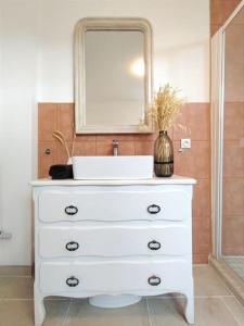 a white dresser with a sink and a mirror at Caen au fil de l'eau in Caen +45 photos