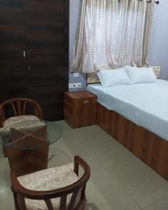 Llit o llits en una habitació de Hotel palash