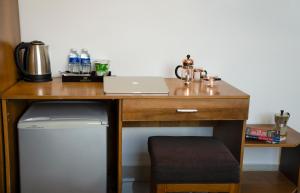 a wooden desk with a laptop on top of it at Trang Ngan Hotel by THG in Danang