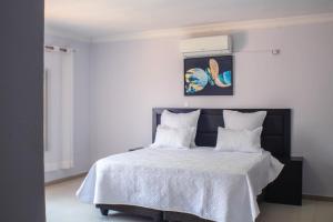 Postel nebo postele na pokoji v ubytování Kachimam Homes