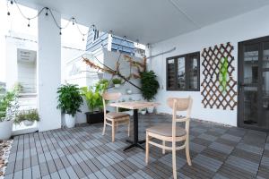 a patio with a table and chairs and plants at X-Stay Thư Trung in Hai Phong