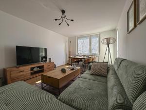 a living room with a couch and a flat screen tv at Fisherman's AREA 4-Room Large Apartment in Šamorín
