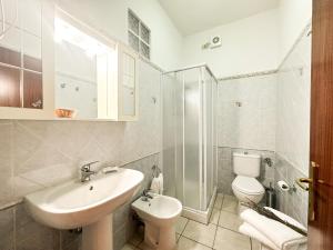 a bathroom with a sink and a toilet and a shower at Agriturismo La Rondine in Bolgheri +38 photos