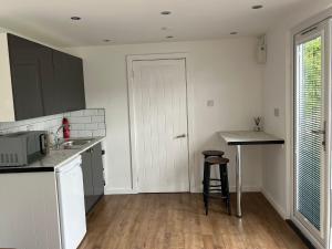 a kitchen with a sink and a counter top at Ty Sycamore in Talybont