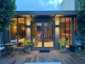 a house with sliding glass doors on a deck at City Oasis in The Hague