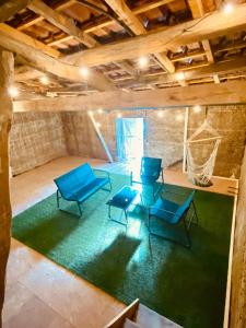 a room with three blue chairs and a net at Le Loft de l Horloge in Lescure-dʼAlbigeois