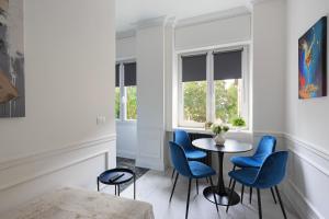 a dining room with blue chairs and a table at Gramsci Baveno in Baveno
